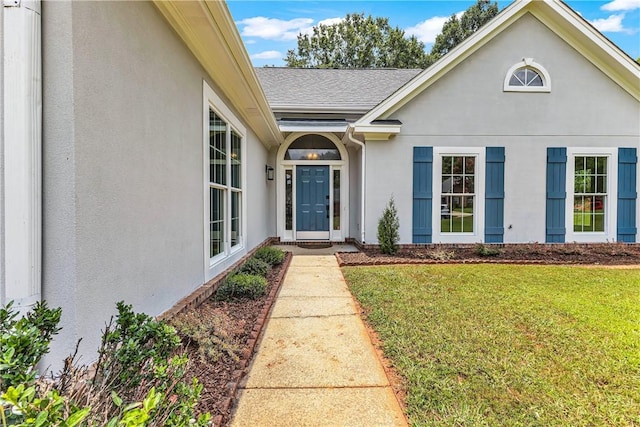 1661 S Camden Ct, Auburn, AL 36830 - doorway to property featuring stucco siding, a lawn, and a shingled roof