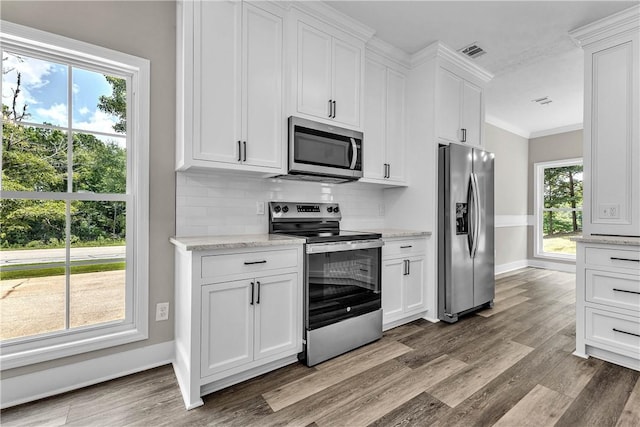 1661 S Camden Ct, Auburn, AL 36830 - kitchen featuring stainless steel appliances, wood finished floors, tasteful backsplash, white cabinetry, and crown molding