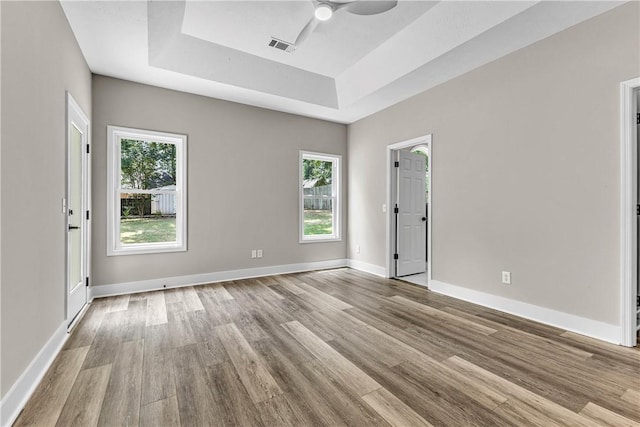 1661 S Camden Ct, Auburn, AL 36830 - unfurnished room with a raised ceiling, wood finished floors, plenty of natural light, and ceiling fan