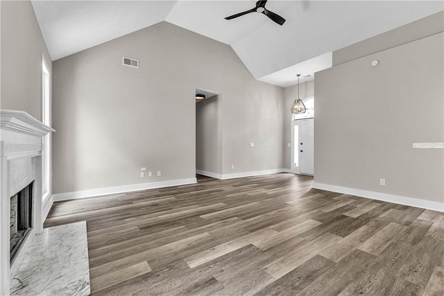 1661 S Camden Ct, Auburn, AL 36830 - unfurnished living room featuring ceiling fan, high vaulted ceiling, a high end fireplace, and wood finished floors