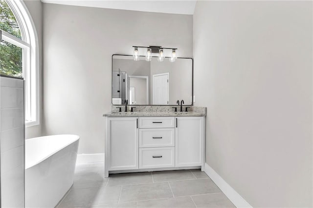 1661 S Camden Ct, Auburn, AL 36830 - bathroom with double vanity, a freestanding tub, and tile patterned flooring