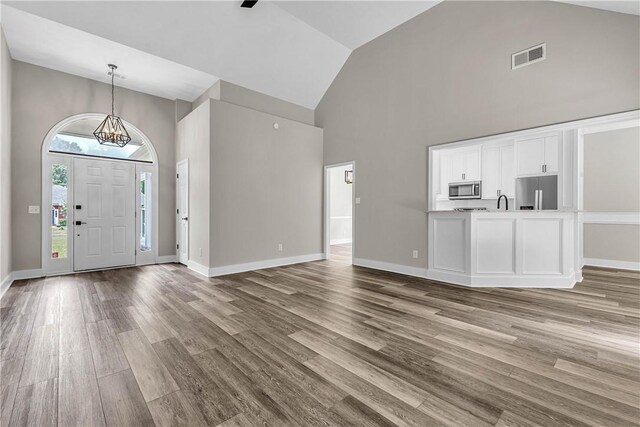 1661 S Camden Ct, Auburn, AL 36830 - entryway with high vaulted ceiling, wood finished floors, and a chandelier