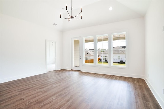 112 Hunters Way, Opelika, AL 36801 - unfurnished living room featuring a chandelier, dark wood finished floors, baseboards, and a high ceiling