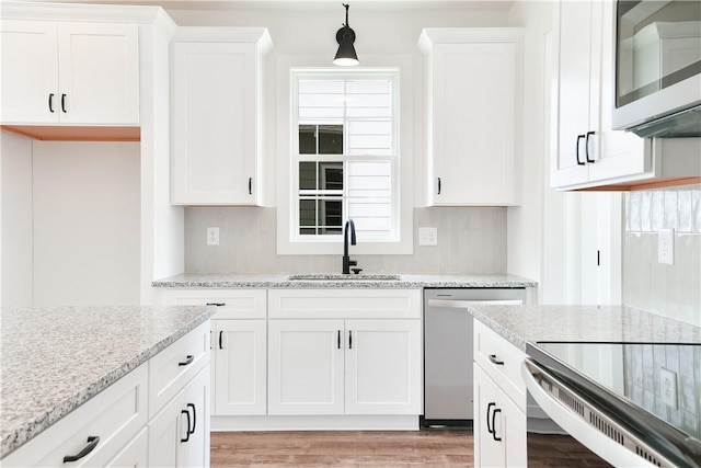 112 Hunters Way, Opelika, AL 36801 - kitchen featuring a sink, stainless steel appliances, white cabinets, and light wood-style flooring