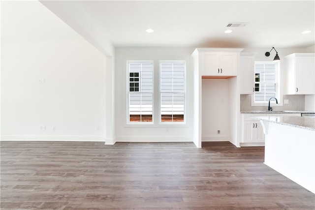 112 Hunters Way, Opelika, AL 36801 - kitchen with white cabinetry, light stone countertops, light wood finished floors, baseboards, and recessed lighting