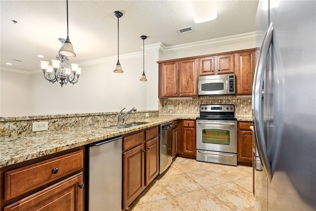 234 W Magnolia Ave Unit 305, Auburn, AL 36830 - kitchen featuring stainless steel appliances, a sink, crown molding, brown cabinets, and backsplash
