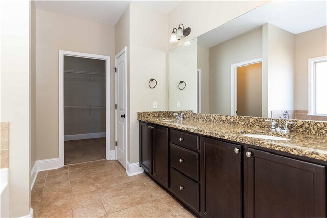 8 Ivy Loop, Phenix City, AL 36867 - bathroom with double vanity, a bath, and a spacious closet