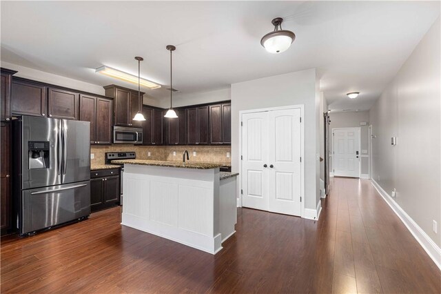 8 Ivy Loop, Phenix City, AL 36867 - kitchen featuring appliances with stainless steel finishes, backsplash, dark brown cabinetry, light stone countertops, and dark wood-style floors