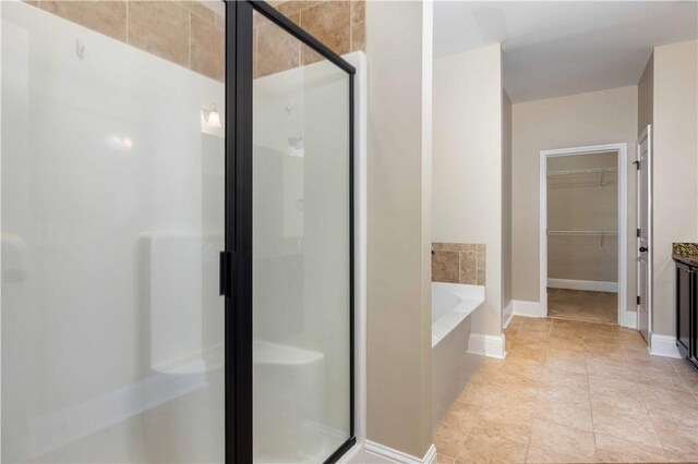 8 Ivy Loop, Phenix City, AL 36867 - full bath with a shower stall, a walk in closet, a bath, and tile patterned flooring