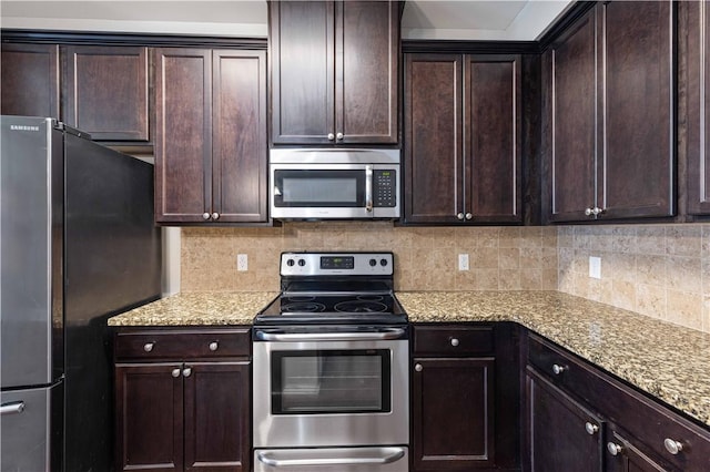 8 Ivy Loop, Phenix City, AL 36867 - kitchen with appliances with stainless steel finishes, dark brown cabinetry, and backsplash