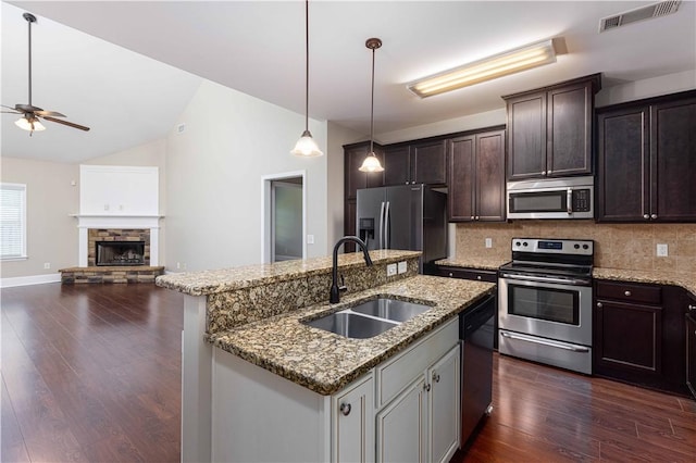 8 Ivy Loop, Phenix City, AL 36867 - kitchen with appliances with stainless steel finishes, lofted ceiling, decorative backsplash, dark wood-style floors, and dark brown cabinets