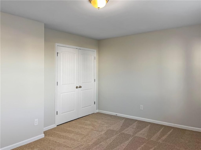 unfurnished bedroom with carpet and a closet