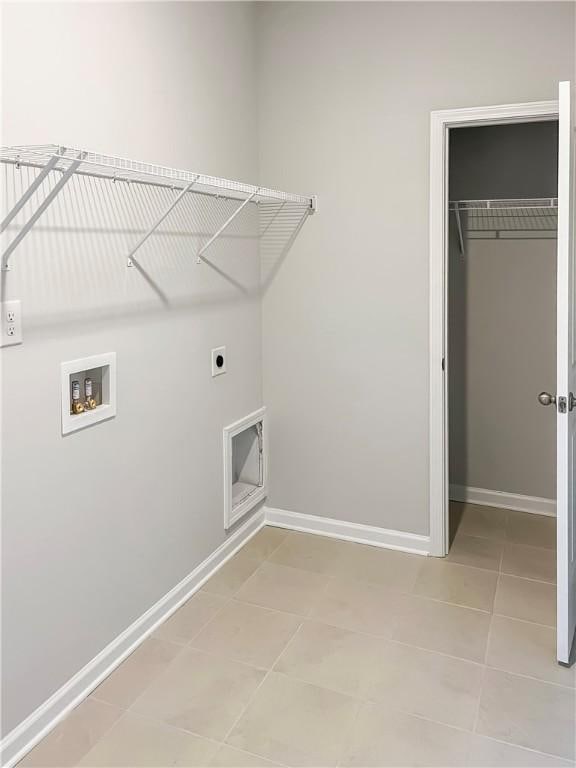 laundry room with washer hookup, hookup for an electric dryer, and light tile patterned flooring