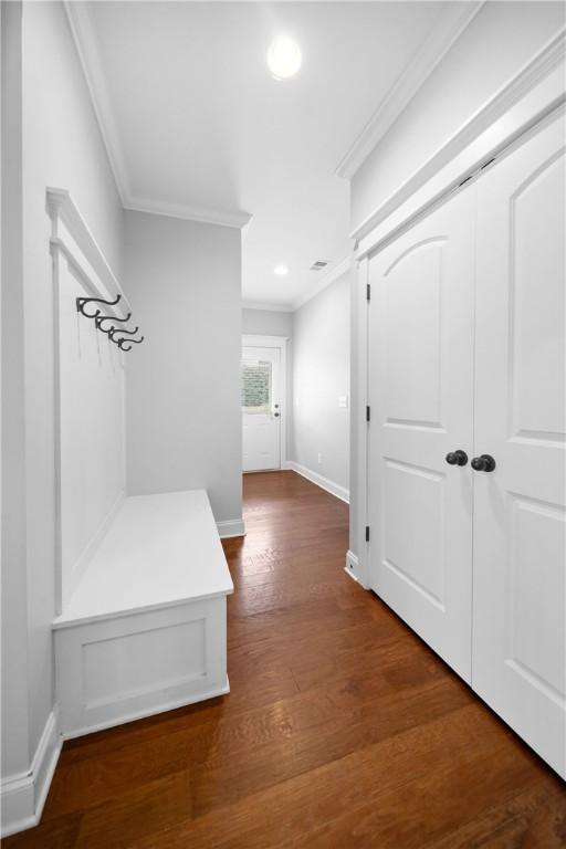 mudroom with crown molding and dark hardwood / wood-style floors