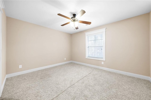 spare room featuring carpet and ceiling fan