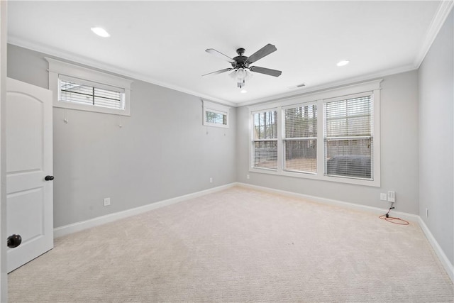 empty room featuring ornamental molding, light colored carpet, and ceiling fan