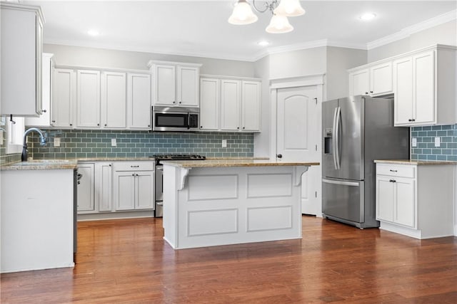 kitchen with stainless steel appliances, a center island, and white cabinets