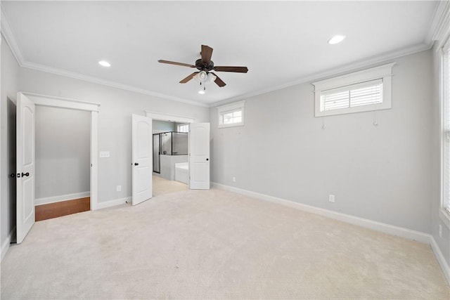 unfurnished bedroom featuring crown molding, ensuite bath, and light carpet