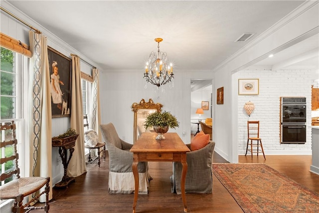 2521 Middle Brook Ln, Auburn, AL 36832 - dining area featuring a chandelier, wood finished floors, and ornamental molding