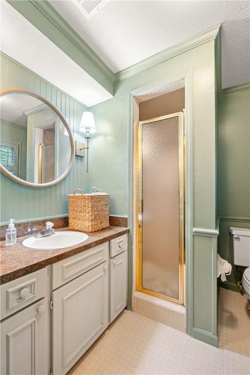 2521 Middle Brook Ln, Auburn, AL 36832 - full bath featuring vanity, a shower stall, ornamental molding, and a decorative wall