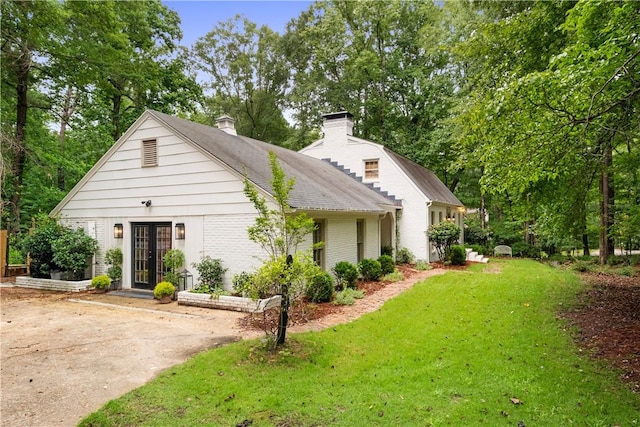 2521 Middle Brook Ln, Auburn, AL 36832 - view of front of house featuring french doors, a front yard, a chimney, and brick siding