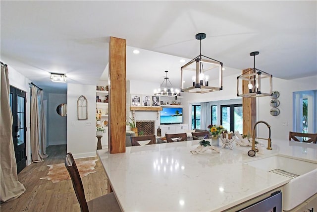 3897 Moores Mill Rd, Auburn, AL 36830 - kitchen featuring open floor plan, a chandelier, wood finished floors, and healthy amount of natural light