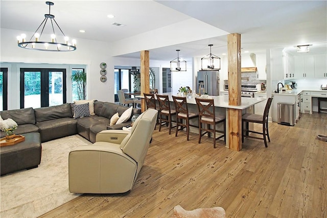 3897 Moores Mill Rd, Auburn, AL 36830 - living room featuring a chandelier, light wood-type flooring, and recessed lighting