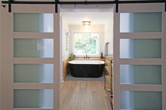 3897 Moores Mill Rd, Auburn, AL 36830 - bathroom with a soaking tub and wood finished floors