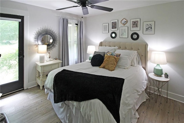 3897 Moores Mill Rd, Auburn, AL 36830 - bedroom featuring multiple windows, wood finished floors, and a ceiling fan