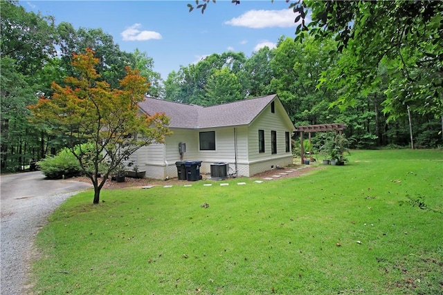 3897 Moores Mill Rd, Auburn, AL 36830 - view of side of property featuring a yard, driveway, and a shingled roof