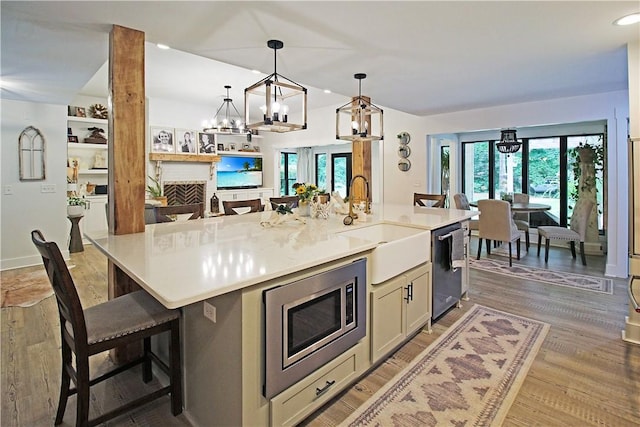 3897 Moores Mill Rd, Auburn, AL 36830 - kitchen with a chandelier, stainless steel appliances, light countertops, decorative light fixtures, and light wood finished floors