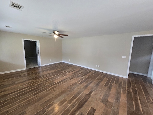 spare room with ceiling fan and dark wood-type flooring