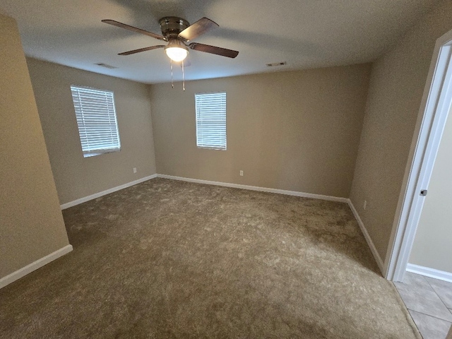 carpeted empty room featuring ceiling fan