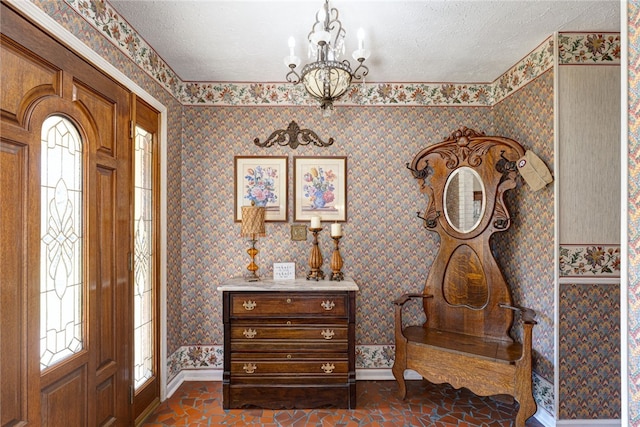 2071 County Road 63, Tuskegee, AL 36083 - foyer entrance with baseboards, a chandelier, a textured ceiling, wallpapered walls, and dark tile patterned flooring