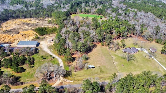 drone / aerial view with a wooded view