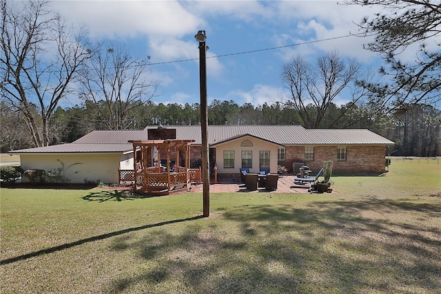 2071 County Road 63, Tuskegee, AL 36083 - rear view of property with metal roof, a lawn, a patio area, and a deck