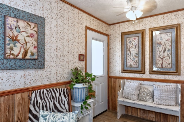 2071 County Road 63, Tuskegee, AL 36083 - living area featuring crown molding, wood finished floors, ceiling fan, wallpapered walls, and wainscoting