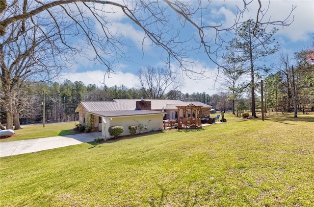 2071 County Road 63, Tuskegee, AL 36083 - view of green lawn with concrete driveway and a deck