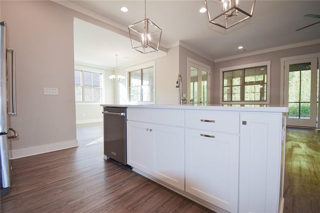 kitchen with white cabinetry, decorative light fixtures, stainless steel appliances, and a chandelier