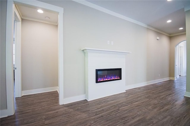 unfurnished living room featuring ornamental molding and dark hardwood / wood-style flooring
