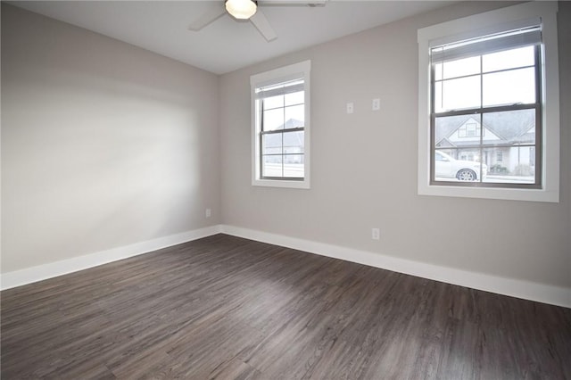 empty room with dark hardwood / wood-style floors and ceiling fan