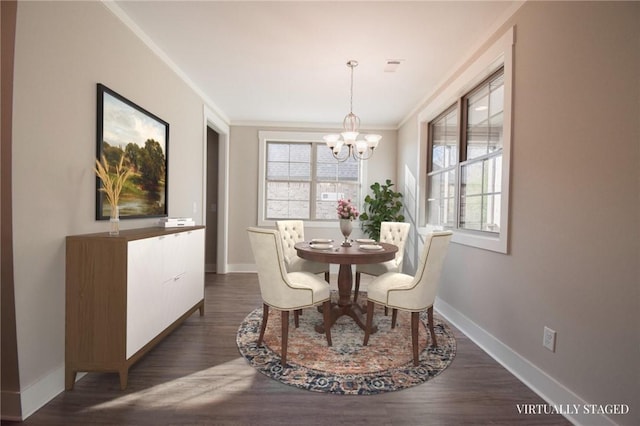 dining space featuring ornamental molding, dark wood-type flooring, and a chandelier