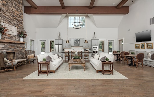 living room featuring a healthy amount of sunlight, a fireplace, and a chandelier