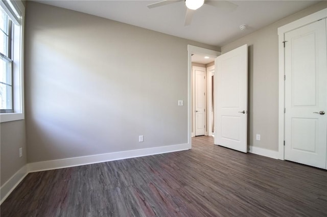 unfurnished bedroom with dark hardwood / wood-style floors and ceiling fan