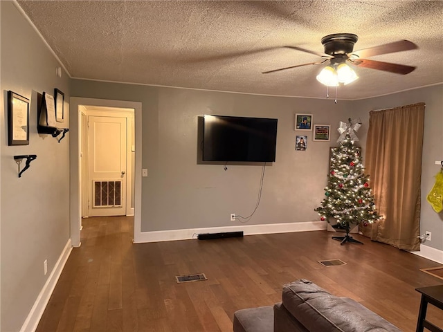 unfurnished living room featuring dark hardwood / wood-style floors, ceiling fan, and a textured ceiling