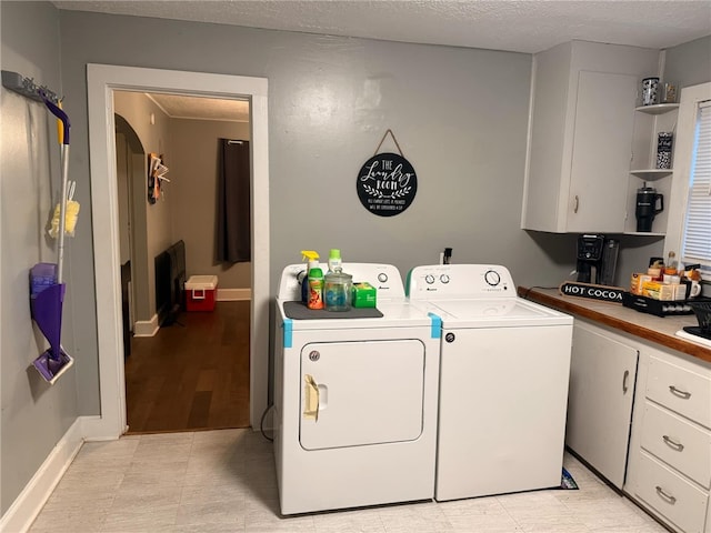 washroom featuring cabinets and independent washer and dryer