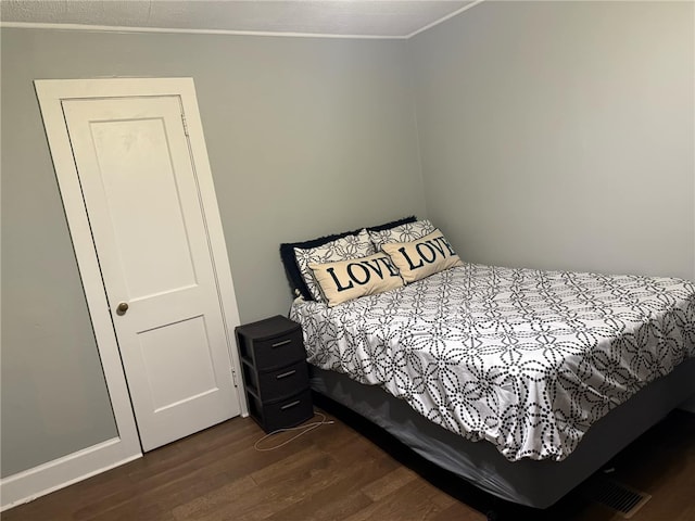 bedroom with dark wood-type flooring