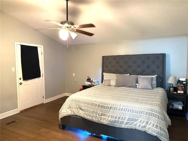 bedroom featuring ceiling fan, dark hardwood / wood-style flooring, and lofted ceiling