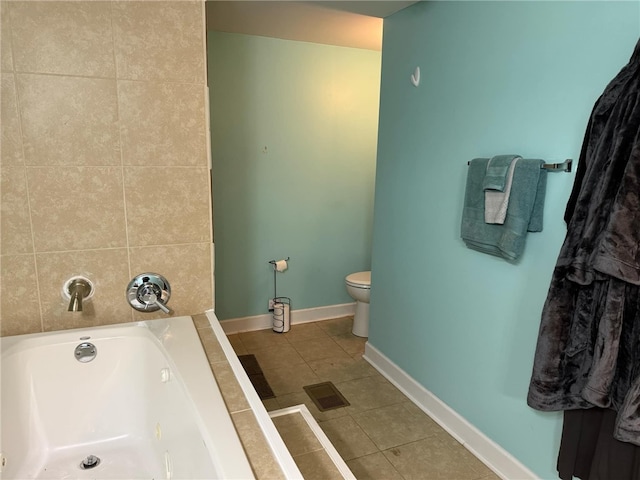 bathroom with tile patterned flooring, toilet, and a tub