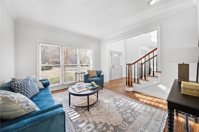 living room with ornamental molding and hardwood / wood-style flooring